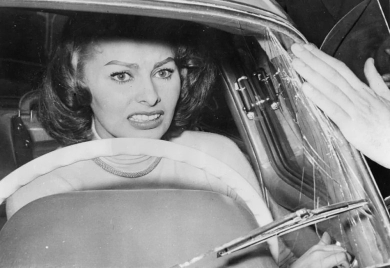 Sophia Loren Surrounded by Fans: A nervous moment for actress Sophia Loren as she hides in her car, besieged by excited fans, during the Rome-San Remo car rally on April 9, 1956.